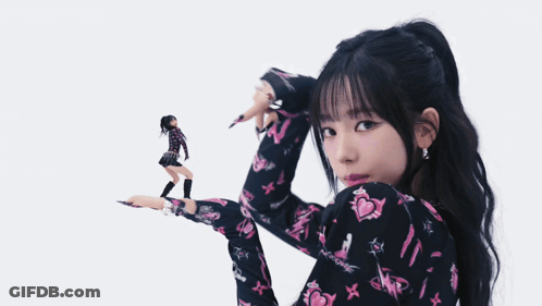 Woman In Black And Pink Floral Shirt Holding Doll GIF