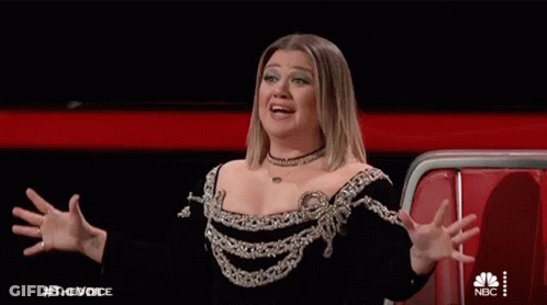 Woman In Black And Silver Dress With Hands In Air GIF