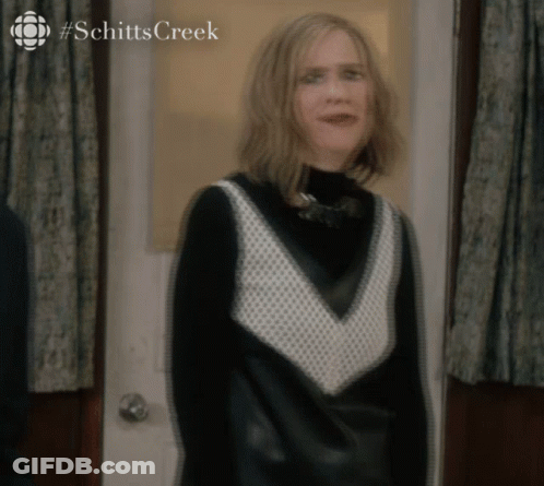 Woman In Black And White Dress At Schitt's Creek Door GIF