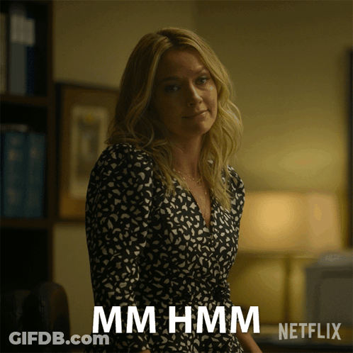 Woman In Black And White Dress Says Mmhmm Netflix Advertisement GIF