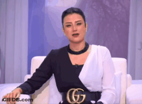 Woman In Black And White Dress Sitting GIF