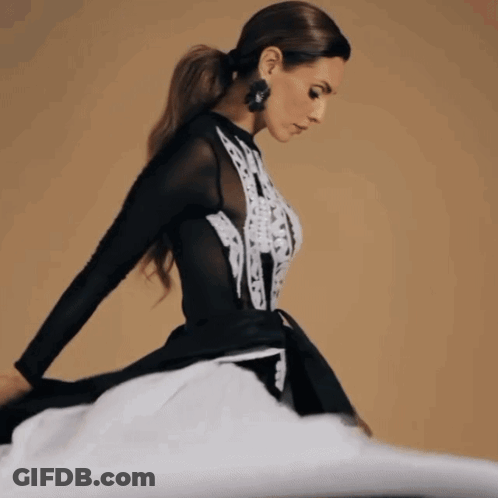 Woman In Black And White Dress With Earrings GIF