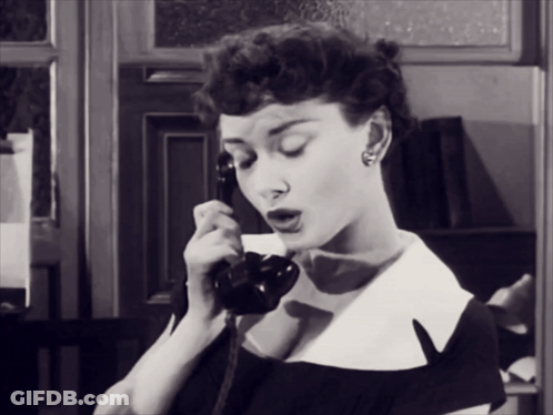 Woman In Black And White Photo Talking On Phone GIF