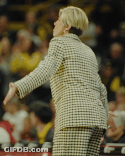 Woman In Black And White Plaid Jacket In Front Of Crowd GIF