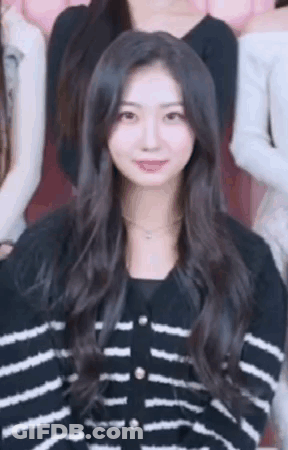 Woman In Black And White Striped Sweater Standing In Group GIF