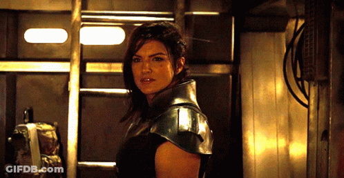 Woman In Black Armor Standing In Room GIF