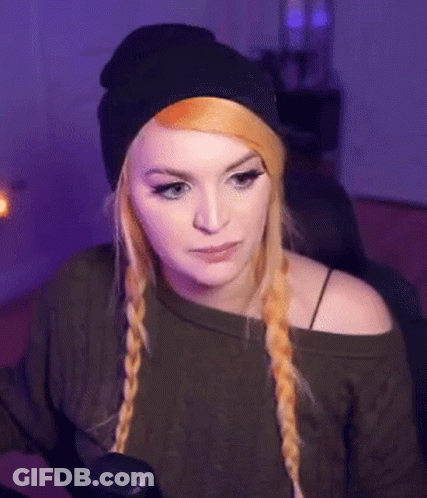 Woman In Black Beanie And Green Sweater Sitting In Chair GIF