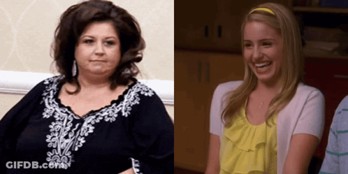 Woman In Black Beside Blonde In Yellow Shirt GIF