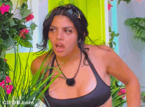 Woman In Black Bikini Top In Flower Garden GIF