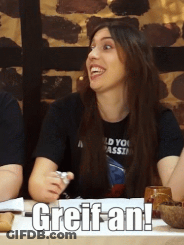 Woman In Black Bikini Top Sits At Table GIF