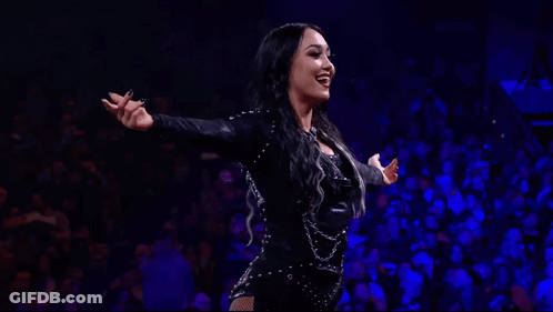 Woman In Black Bodysuit Dancing In Front Of Crowd GIF