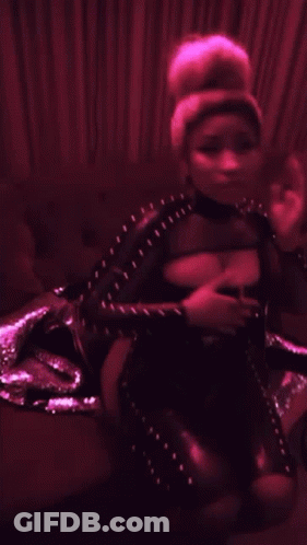 Woman In Black Bodysuit Sitting On Couch In Dark Room GIF