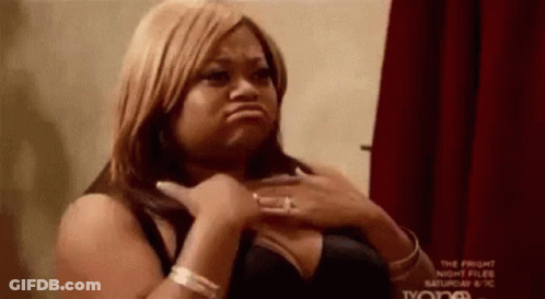Woman In Black Bra Making Funny Face Hands On Chest GIF