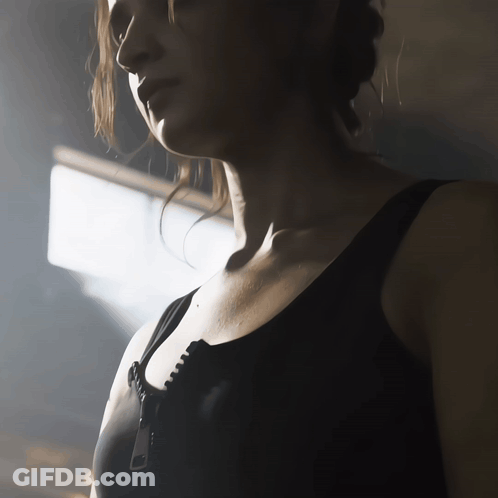 Woman In Black Bra With City Skyline GIF