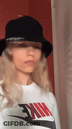 Woman In Black Bucket Hat And White Nike Shirt GIF