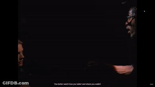 Woman In Black Coat Talking To Man In Black Suit GIF