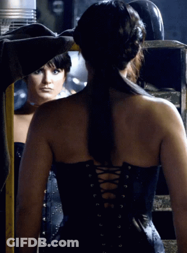 Woman In Black Corset Looking In Mirror GIF