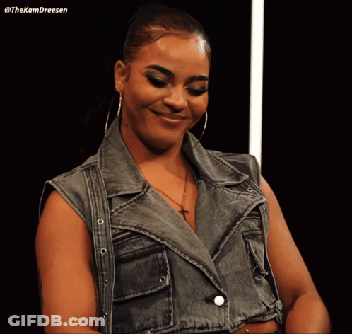 Woman In Black Crop Top And Fishnet Stockings With Yellow Sign N GIF