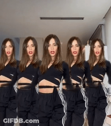 Woman In Black Crop Top And Pants Standing In Row GIF