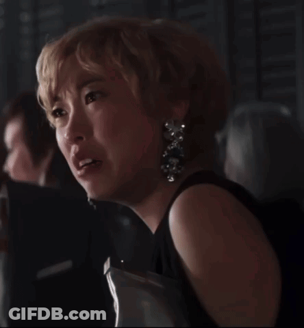 Woman In Black Dress And Earrings Crying In Dark Room GIF