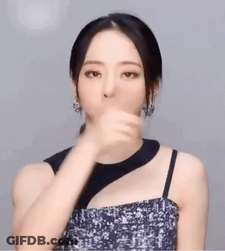 Woman In Black Dress And Earrings Gesturing GIF