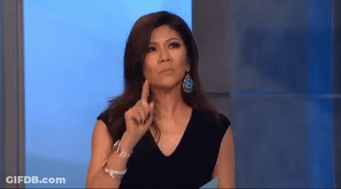 Woman In Black Dress And Earrings Pointing Funny Face GIF