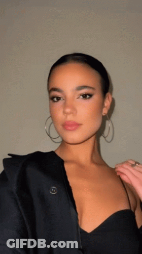 Woman In Black Dress And Hoop Earrings GIF