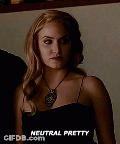 Woman In Black Dress And Necklace Says Neutral Pretty GIF
