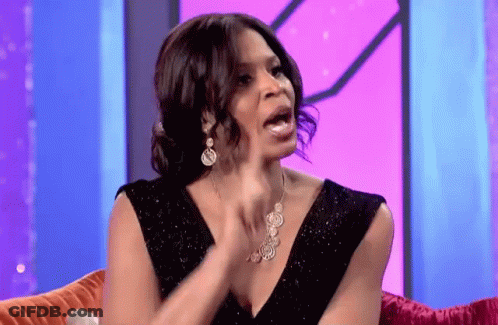 Woman In Black Dress And Necklace Sitting GIF