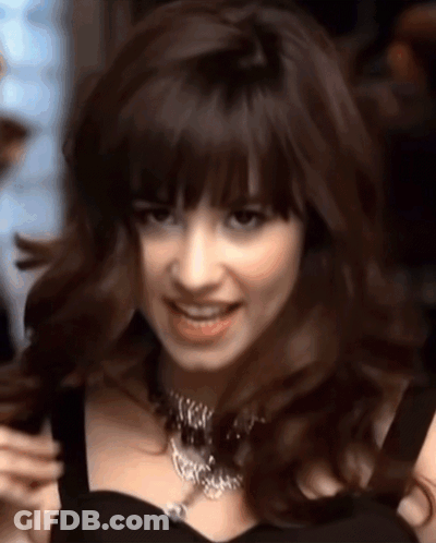 Woman In Black Dress And Necklace Smiling GIF