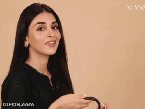 Woman In Black Dress And Purse By Mask Sign GIF