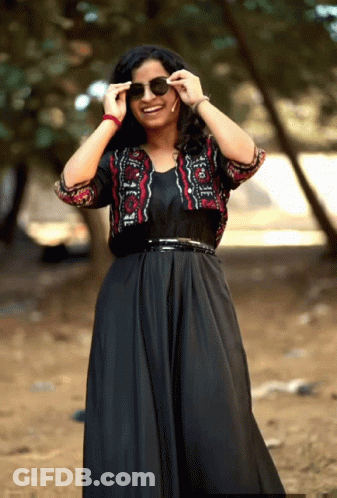 Woman In Black Dress And Red Black Jacket GIF