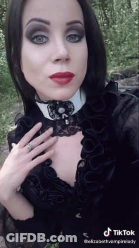 Woman In Black Dress And White Collar TikTok Watermark GIF