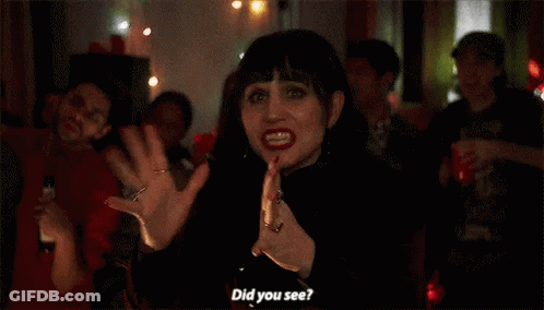 Woman In Black Dress Before Crowd GIF