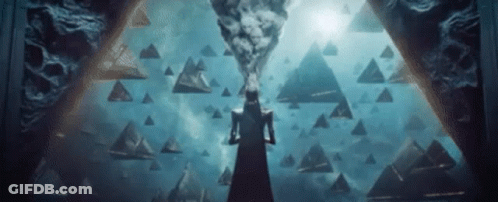 Woman In Black Dress Before Pyramid In Darkness GIF