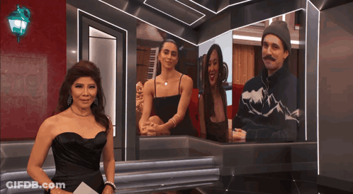 Woman In Black Dress By Screen With Man And Two Women GIF