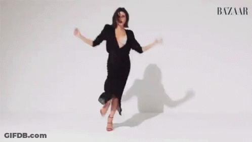 Woman In Black Dress Dancing Arms Outstretched GIF