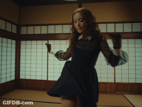 Woman In Black Dress Dancing By Japanese Window GIF