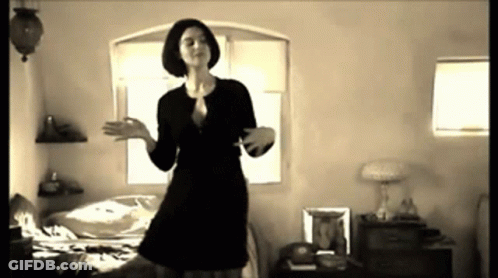 Woman In Black Dress Dancing In Bedroom GIF