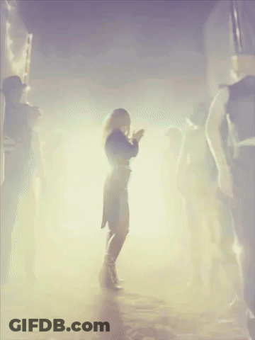 Woman In Black Dress Dancing In Crowd GIF