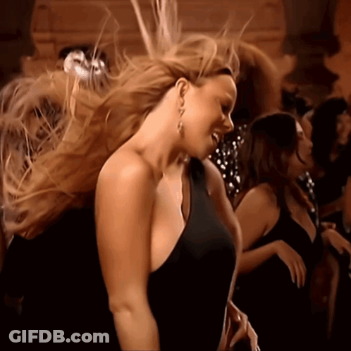 Woman In Black Dress Dancing In Crowd GIF