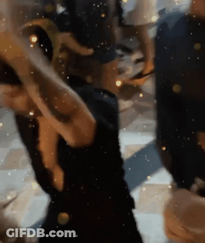 Woman In Black Dress Dancing In Dark Room GIF