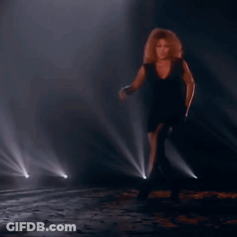 Woman In Black Dress Dancing On Stage GIF
