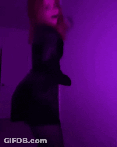 Woman In Black Dress Dancing Under Purple Lights GIF