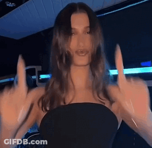 Woman In Black Dress Giving Middle Finger GIF