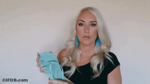 Woman In Black Dress Holding Blue Item GIF