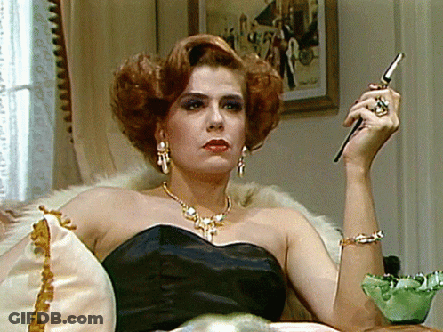 Woman In Black Dress Holding Cell Phone GIF