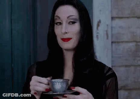 Woman In Black Dress Holding Coffee Cup GIF