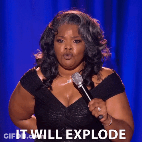 Woman In Black Dress Holding Microphone Saying It Will Explode GIF