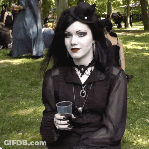Woman In Black Dress Holding Plastic Cup GIF